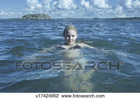 Young Woman Swimming in the Sea. View Large Photo Image Stock Image - Young Woman Swimming in the Sea.. Fotosearch