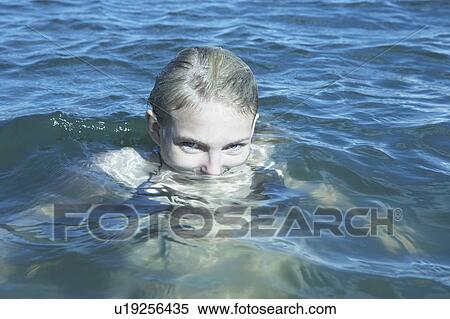 Stock Photography - Young Woman Swimming in the Sea.. Fotosearch