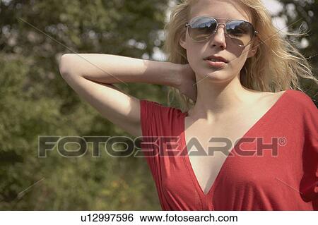 Stock Photograph - Young Woman wearing red dress.. Fotosearch