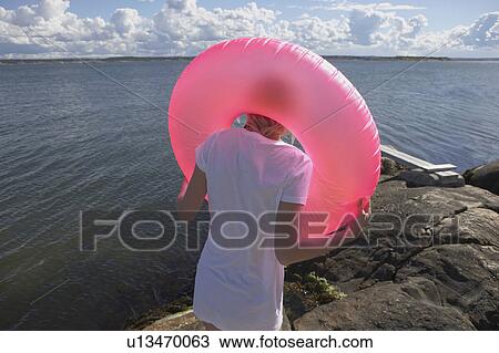 Stock Image - Young woman with swimming ring.. Fotosearch