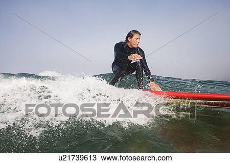 Man surfing a wave. View Large Photo Image Stock Image - Man surfing a wave.. Fotosearch