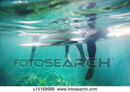 Couple's legs and surfboards underwater. View Large Photo Image Stock Photo - Couple's legs and surfboards underwater.. Fotosearch