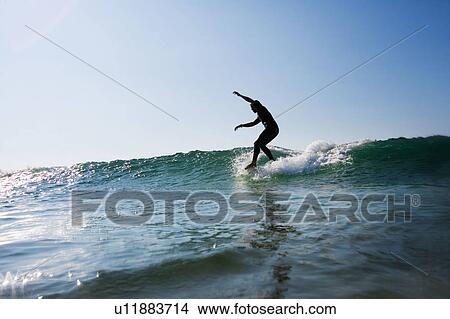 Man surfing a wave. View Large Photo Image Picture - Man surfing a wave.. Fotosearch