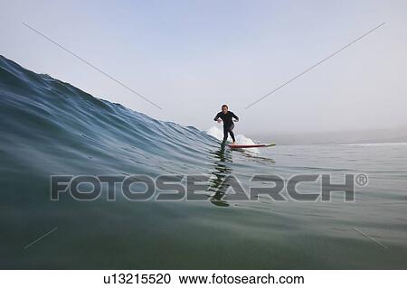 Man surfing a wave. View Large Photo Image Stock Image - Man surfing a wave.. Fotosearch