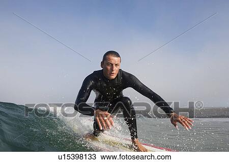 Man surfing a wave. View Large Photo Image Stock Image - Man surfing a wave.. Fotosearch