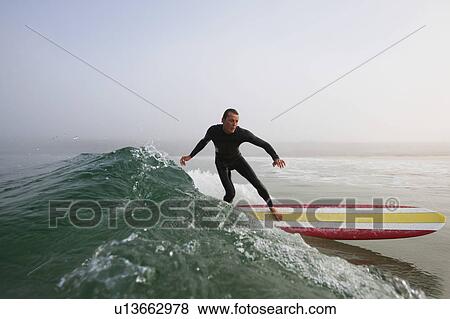 Man surfing a wave. View Large Photo Image Stock Photo - Man surfing a wave.. Fotosearch