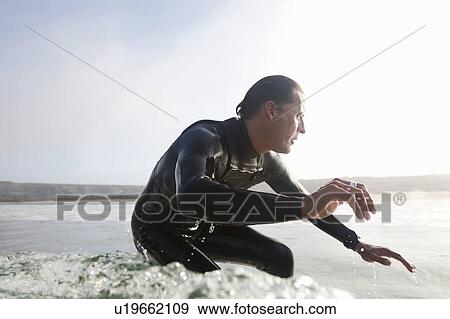 Stock Photo - Man surfing a wave.. Fotosearch