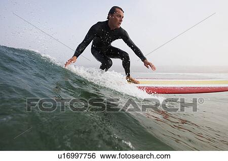 Stock Photograph - Man surfing a wave.. Fotosearch