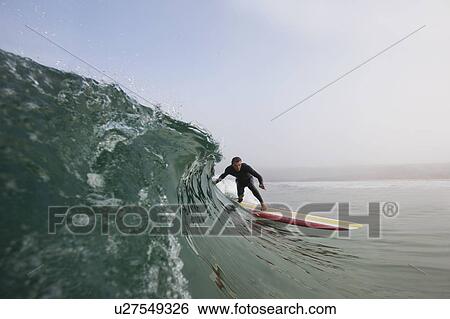 Stock Photograph - Man surfing a wave.. Fotosearch