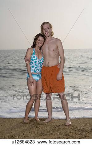 Couple standing on the beach. View Large Photo Image Stock Image - Couple standing on the beach.. Fotosearch