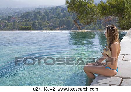 Stock Image - Young woman at a pool.. Fotosearch