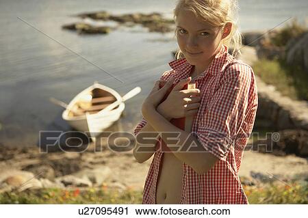 Young woman clutching book. View Large Photo Image Stock Image - Young woman clutching book.. Fotosearch