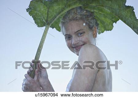 Young Woman sheltering from rain. View Large Photo Image Picture - Young Woman sheltering from rain.. Fotosearch