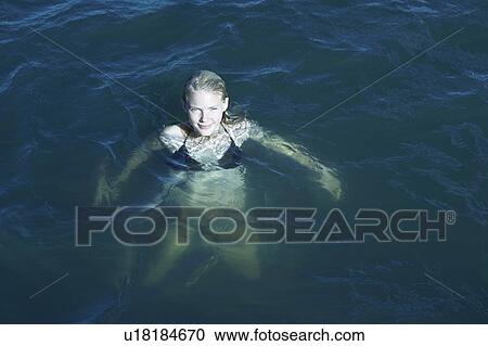 Young Woman Swimming in the Sea. View Large Photo Image Stock Image - Young Woman Swimming in the Sea.. Fotosearch