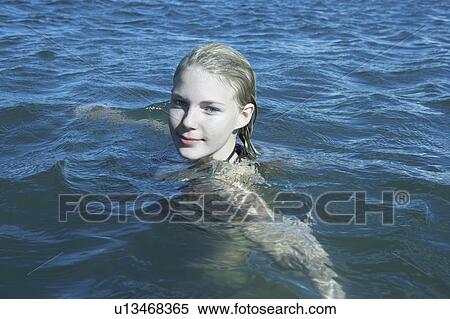 Stock Photography - Young Woman Swimming in the Sea.. Fotosearch