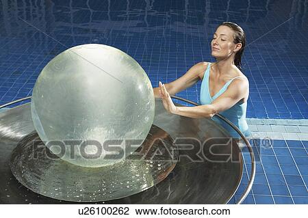 Woman with water globe in pool. View Large Photo Image Stock Image - Woman with water globe in pool.. Fotosearch