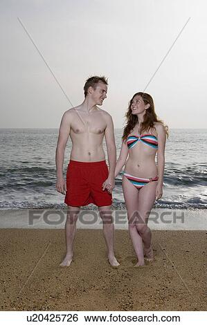 Stock Photograph - Young couple in swimming wear.. Fotosearch