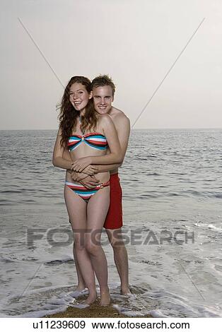 Stock Photo - Young Man holds a woman.. Fotosearch