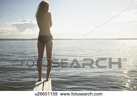 Stock Photo - Young woman on diving board.. Fotosearch