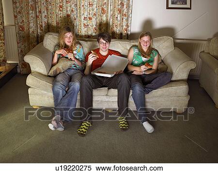 Females and male on sofa, eating pizza View Large Photo Image Stock Photography - Females and male on sofa, eating pizza. Fotosearch
