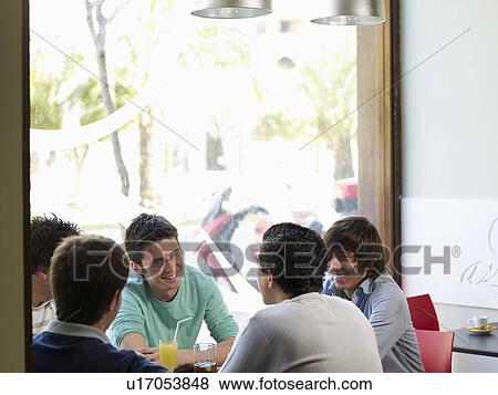 Group of teenage males talking in a cafe View Large Photo Image Stock Photo - Group of teenage males talking in a cafe. Fotosearch