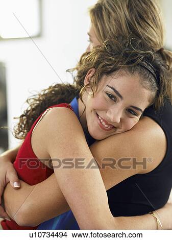 Mother and daughter embracing View Large Photo Image Picture - Mother and daughter embracing. Fotosearch