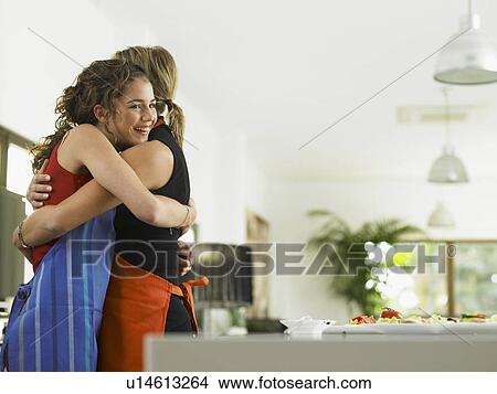 Picture - Mother and daughter embracing. Fotosearch