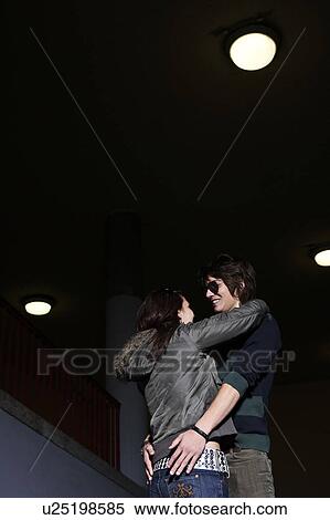 Young couple embracing low view View Large Photo Image Stock Photography - Young couple embracing low view. Fotosearch