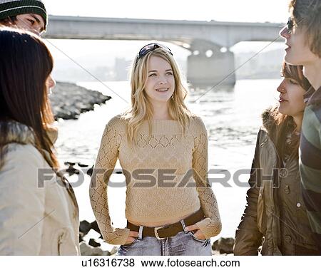 Stock Photo - Young girl with group of friends. Fotosearch
