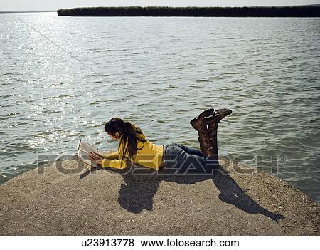 Girl sitting by lake. View Large Photo Image Stock Photo - Girl sitting by lake.. Fotosearch