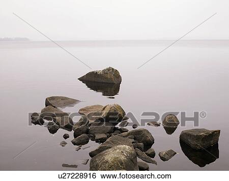 Large rocks in a lake. View Large Photo Image Stock Photograph - Large rocks in a lake.. Fotosearch