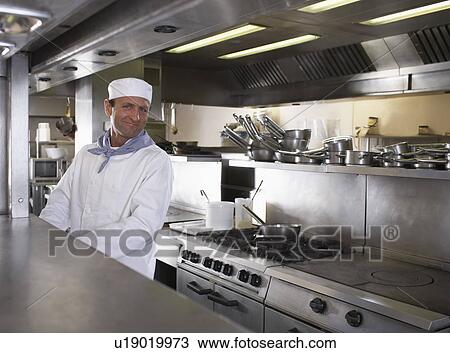 Chef preparing food in his kitchen View Large Photo Image Stock Image - Chef preparing food in his kitchen. Fotosearch