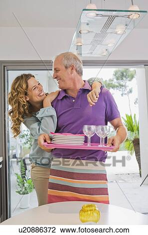 Stock Image - Man and woman in kitchen.. Fotosearch