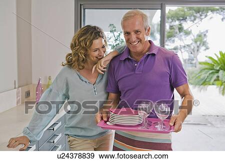Man and woman in kitchen. View Large Photo Image Stock Photo - Man and woman in kitchen.. Fotosearch