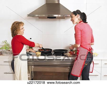 Mature mother and young daughter cooking together, rear view View Large Photo Image Stock Photo - Mature mother and young daughter cooking together, rear view. Fotosearch