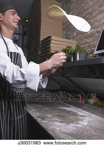 Pizza chef flipping pizza dough View Large Photo Image Stock Image - Pizza chef flipping pizza dough. Fotosearch