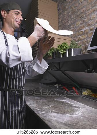 Pizza chef flipping pizza dough View Large Photo Image Stock Photography - Pizza chef flipping pizza dough. Fotosearch