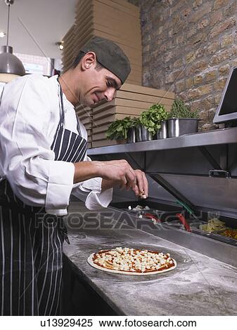 Pizza chef making pizza View Large Photo Image Stock Photography - Pizza chef making pizza. Fotosearch