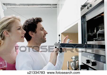 Stock Image - Portrait of a couple cooking.. Fotosearch