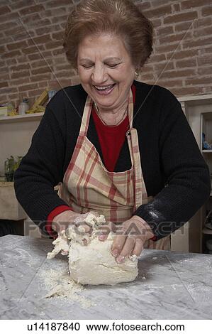 Senior woman kneading dough, smiling View Large Photo Image Stock Image - Senior woman kneading dough, smiling. Fotosearch