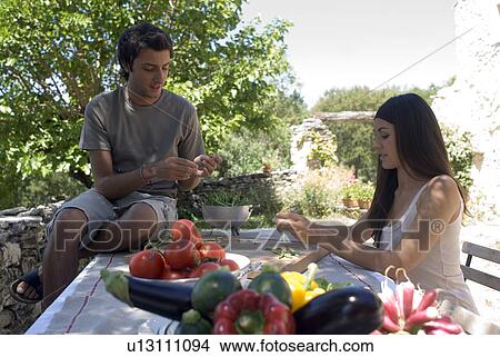 Young couple preparing fresh green beans View Large Photo Image Picture - Young couple preparing fresh green beans. Fotosearch