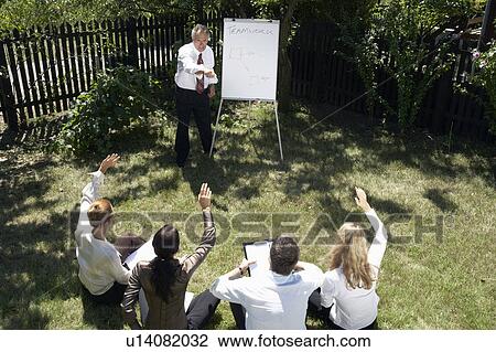 Businesspeople at a rural retreat. View Large Photo Image Stock Image - Businesspeople at a rural retreat.. Fotosearch