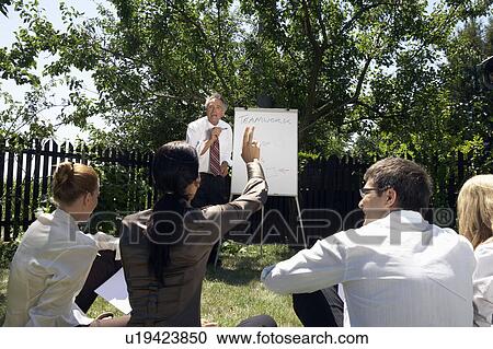 Businesspeople at a rural retreat. View Large Photo Image Stock Image - Businesspeople at a rural retreat.. Fotosearch
