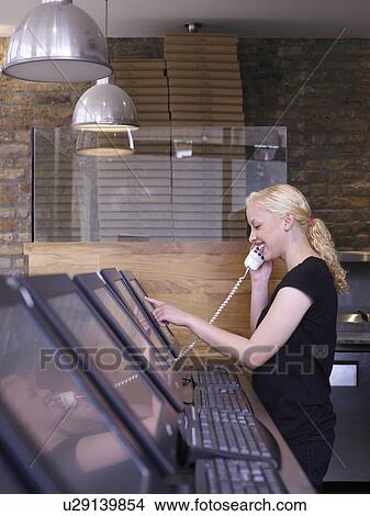 Woman on phone in a restaurant View Large Photo Image Picture - Woman on phone in a restaurant. Fotosearch