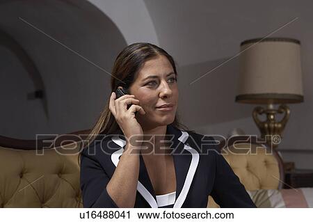 Woman using mobile phone indoors View Large Photo Image Stock Image - Woman using mobile phone indoors. Fotosearch