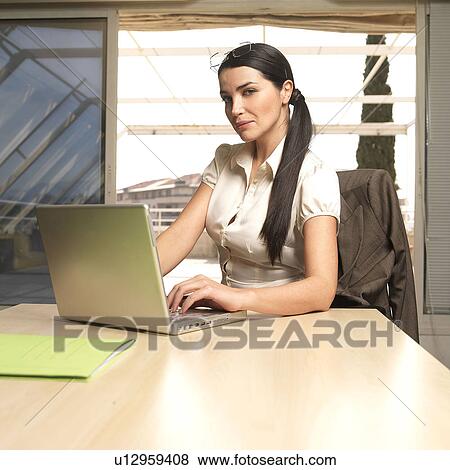 Stock Photo - Woman with laptop, portrait. Fotosearch