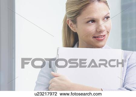 Young Business woman in office with file smiling. View Large Photo Image Stock Image - Young Business woman in office with file smiling.. Fotosearch