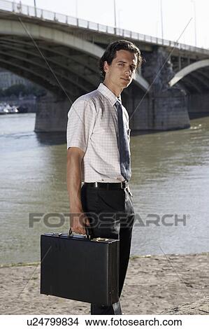 Young businessman by a bridge. View Large Photo Image Picture - Young businessman by a bridge.. Fotosearch