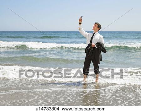 Businessman at the beach. View Large Photo Image Picture - Businessman at the beach.. Fotosearch