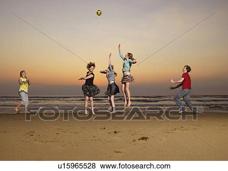 Stock Photo - Five teenagers playing catch.. Fotosearch